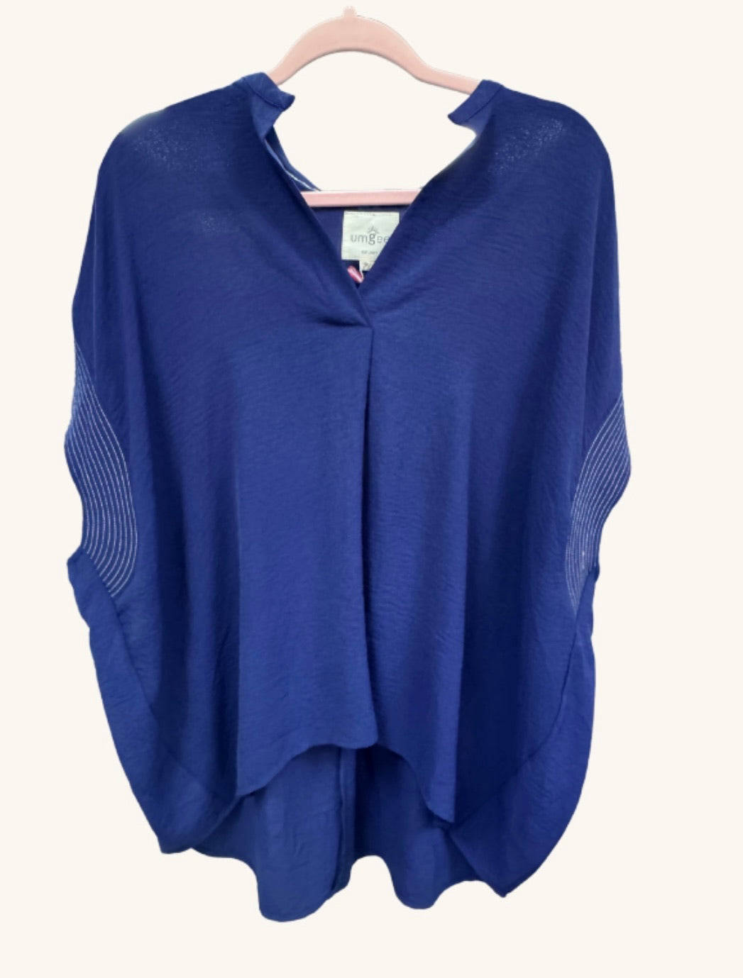 Sail into effortless style with the Midnight Sails Top — a flowy navy poncho blouse featuring a soft V-neckline, lightweight fabric, and relaxed silhouette perfect for any coastal or casual look.
