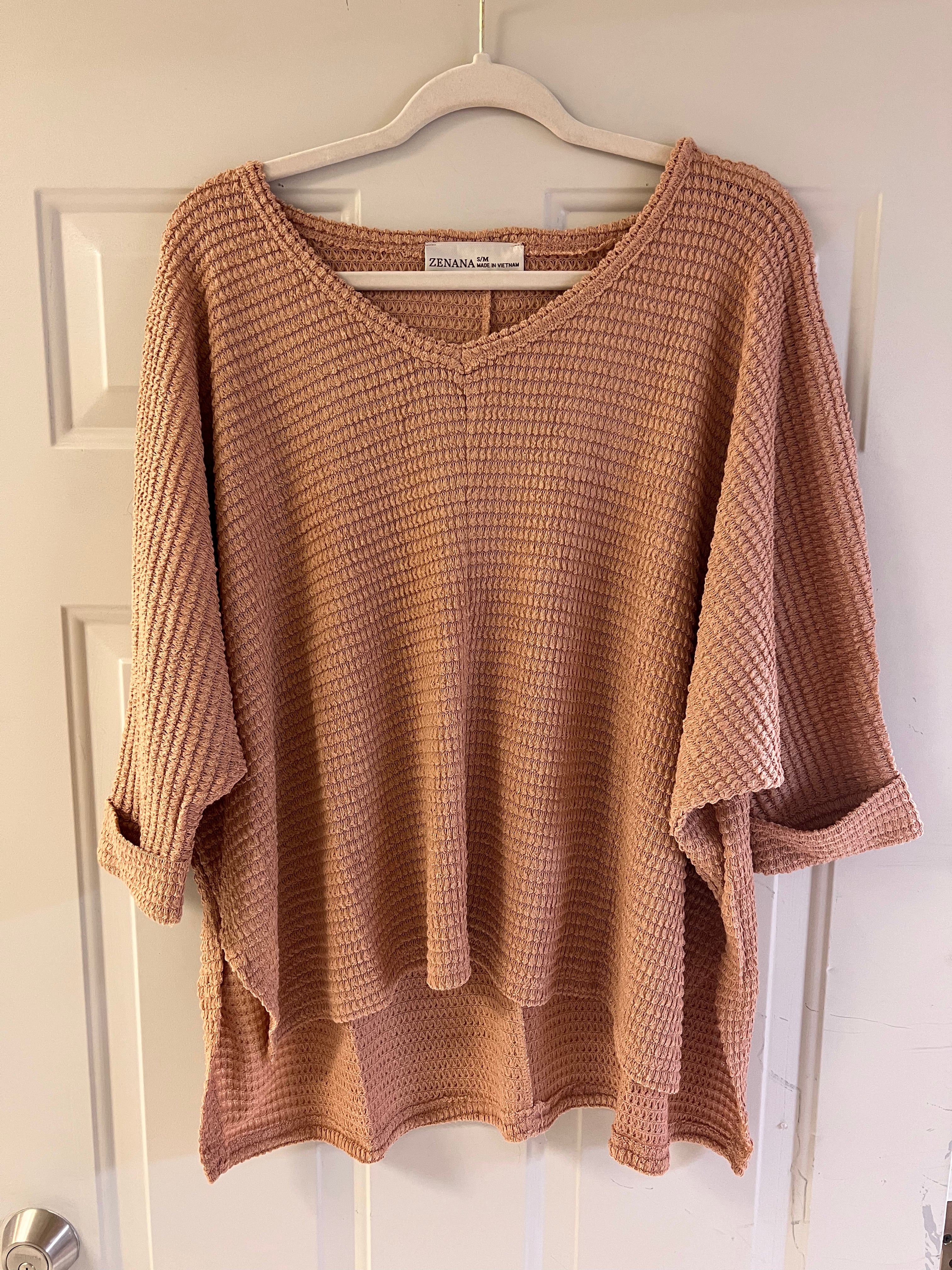Caramel colored textured sweater with a V neckline and flutter sleeves.