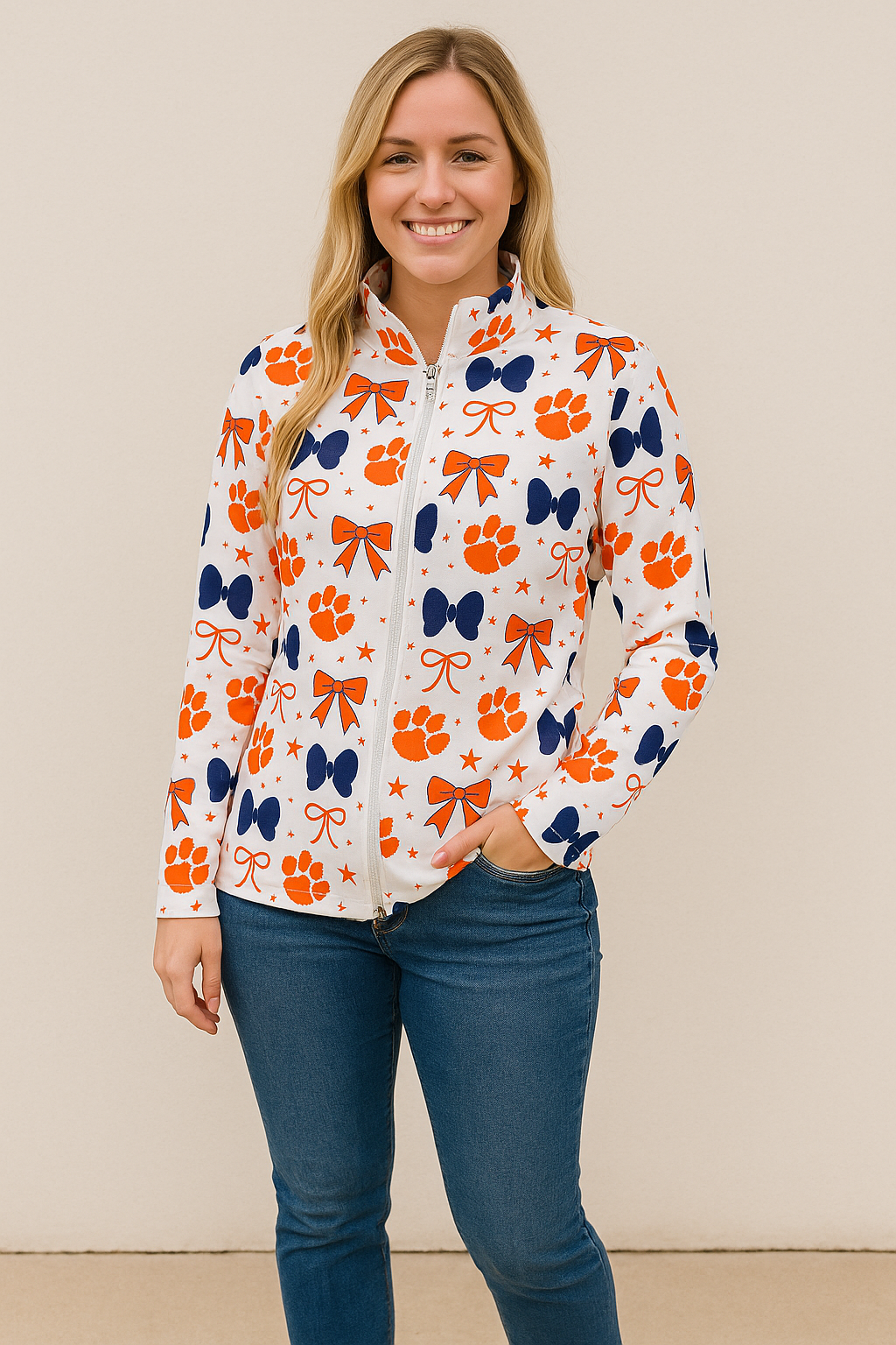 White athletic zip-up pullover with orange tiger paws and bows pattern, women’s game day jacket.