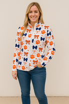 White athletic zip-up pullover with orange tiger paws and bows pattern, women’s game day jacket.