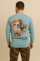 Man wearing a long-sleeve shirt with a graphic of two dogs and a fox, and text on the back.