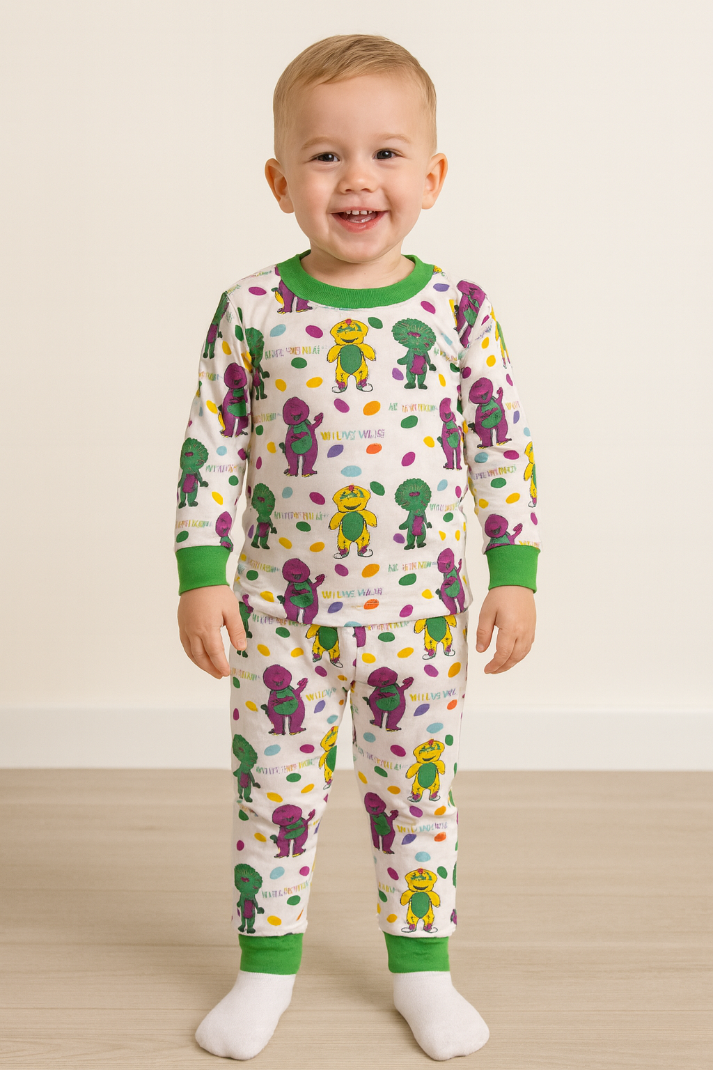 Child wearing a dinosaur-themed pajama set on a plain background