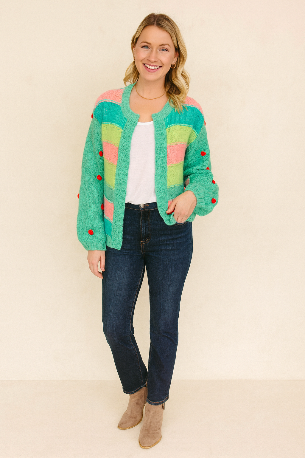 Woman wearing a colorful cardigan with a plain background