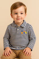 Child wearing a striped shirt with colorful designs on a beige background