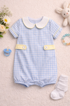 Baby romper with checkered pattern on a neutral background