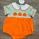 A baby short-sleeve romper laid flat on a dark wood floor. The top half has light green and white horizontal stripes with three orange pumpkin appliques across the chest and a white Peter Pan collar outlined in orange.