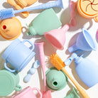 Colorful baby bottle cleaning tools on a light background