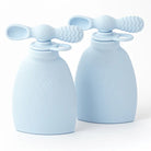 Two light blue silicone baby soothers on a white background