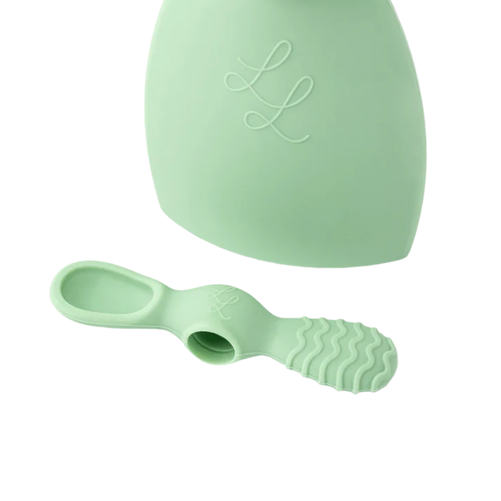 Mint green baby spoon and container set on a white background