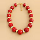  Cherry Red Gold Bead Necklace is a women's red beaded statement necklace with gold-tone spacers.