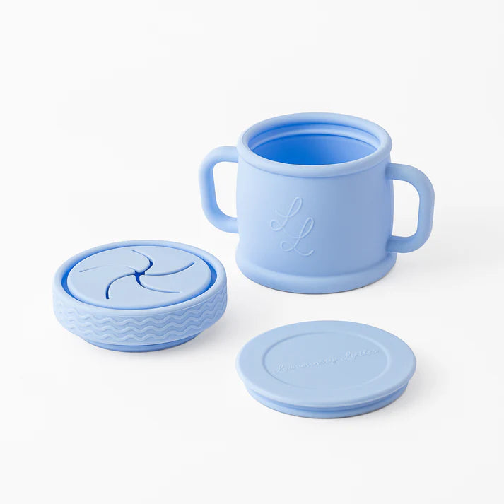 Set of blue silicone cups with lids on a white background