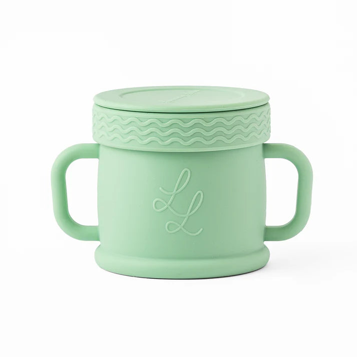 Mint green cup with handle and lid on a white background