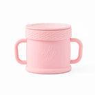 Pink children's cup with handles and textured lid on a white background