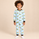 Boy wearing a light blue bird dog print bamboo lounge set with long sleeves, matching pants, and dark brown neckline and cuffs.
