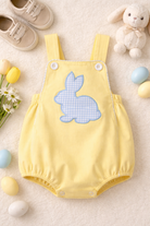 Yellow baby romper with blue bunny design on a light background