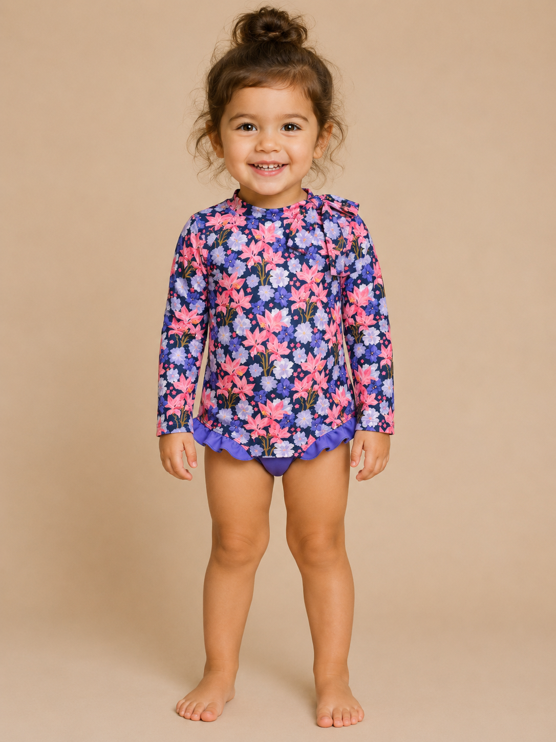 Child wearing a floral swimsuit on a beige background