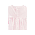 Pink dress with lace details on a white background