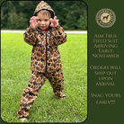 Child wearing a camo print hunting suit standing on grass with promotional text for Southern Belle Outfitters.