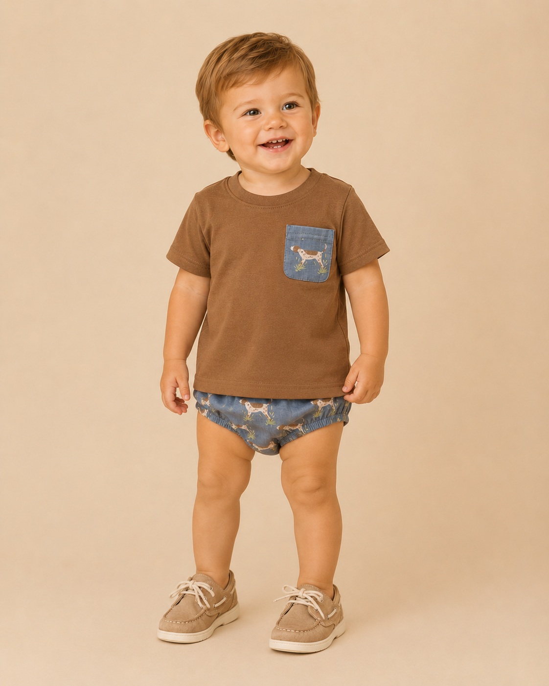 Child wearing a brown t-shirt with a pocket and blue patterned shorts on a beige background