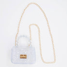Clear handbag with gold chain strap on a white background