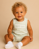 Baby wearing a 'Dad's Boy' Jon Jon on a beige background