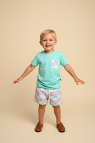 Toddler boy wearing aqua mint shirt with crab print pocket and matching shorts.