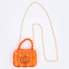 Orange quilted handbag with a chain strap on a white background