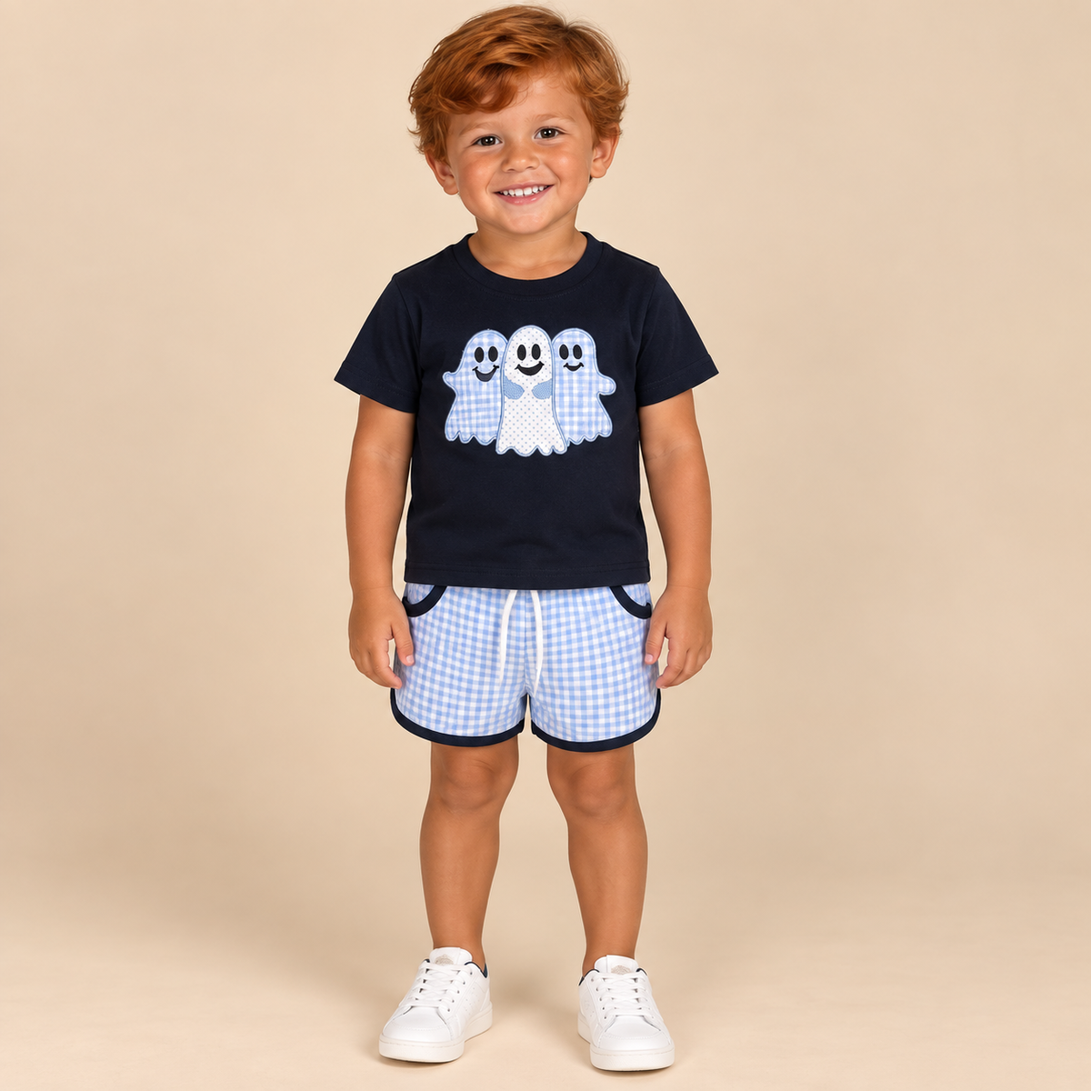 Boy wearing a navy ghost graphic tee with lavender gingham shorts and navy trim