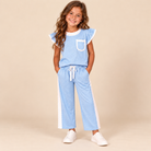 Girl wearing a light blue dotted flutter-sleeve top and matching wide-leg pants with white trim, side panels, and a white waist tie.