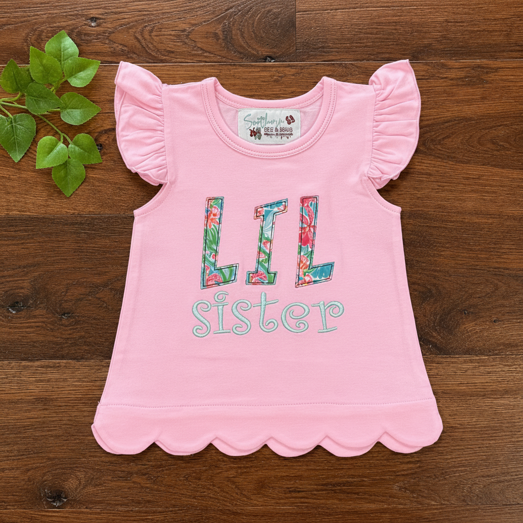LiL Sis LiL Miss Top - flat lay product photo, pink flutter sleeve toddler top with floral LiL sister appliqué