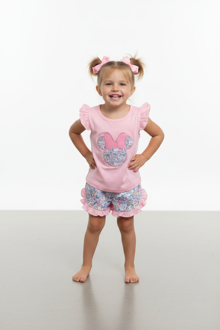 Girl wearing pink flutter sleeve Minnie applique top and floral ruffle shorts