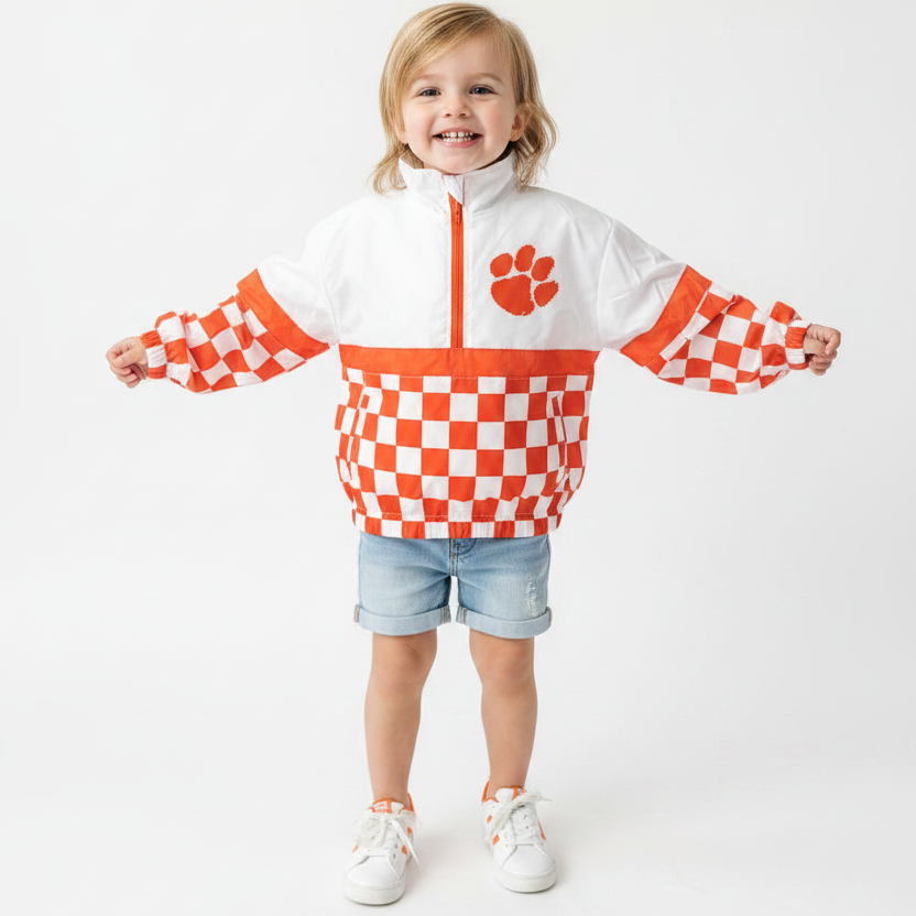 Child wearing orange and white checkered windbreaker, hero shot