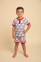 Boy wearing Stars Stripes and Snacks Lounge Set on beige background