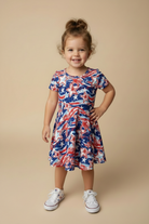 Toddler girl wearing a Patriotic Dress beige background. 