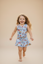 Girl with patriotic outfit on beige background.