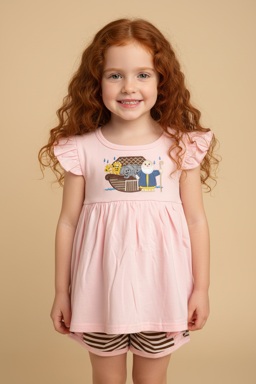 Red hair girl wearing a pink Noah's Ark shit with brown striped shorts.